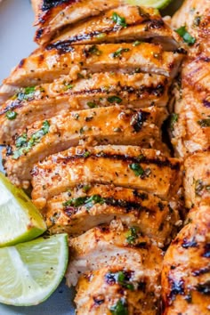 grilled chicken with lime wedges on a plate