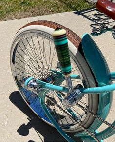 a blue bicycle parked on top of a sidewalk