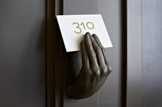 a person's hand is holding up a sign that says 30 on the door