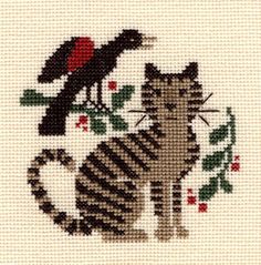 a cross stitch picture with a cat and bird on it