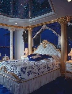 a large bed sitting under a sky filled with stars