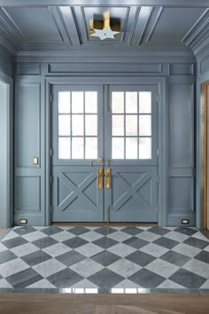 an empty room with blue doors and checkered floor