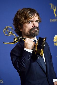 the actor poses with his award for outstanding performance in a musical