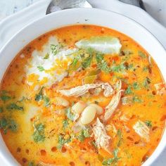 a white bowl filled with soup on top of a table