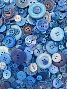 many blue buttons are stacked together