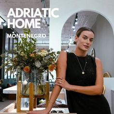 a woman standing next to a vase with flowers in it and the words adriatic home