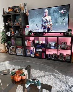 a living room filled with furniture and a flat screen tv mounted on the wall above a coffee table