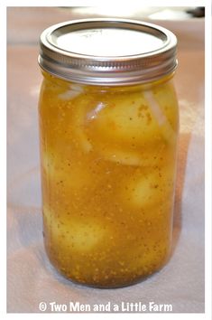 a jar filled with pickles sitting on top of a table