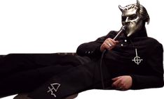 a man wearing a mask sitting on top of a couch holding a pipe in his mouth