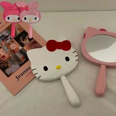 the hello kitty makeup mirror is pink and has a bow on it