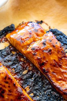 grilled salmon on top of black sesame seeds