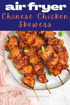 chicken skewers on a plate with text overlay that reads air fryer chinese chicken skewers