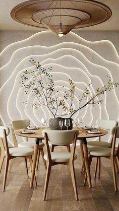 a dining room table with chairs and a vase filled with flowers on top of it