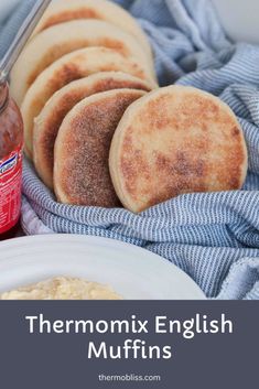 thermomix english muffins on a plate next to a jar of jam