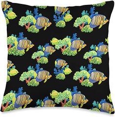 a black pillow with colorful fish and broccoli on the front, along with green plants