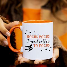 a person holding a coffee mug with the words hoccus pocus i need coffee to focus