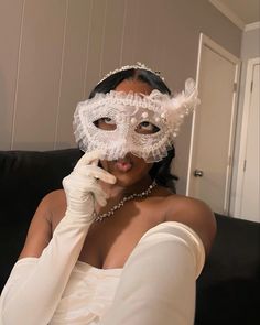 a woman wearing a white mask and gloves