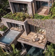 an aerial view of a house with plants growing on the roof and in the ground