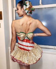 a woman in a dress that has been made to look like a christmas tree skirt