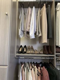 an organized closet with clothes and shoes