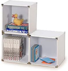 two cubes with books and a rubber duck on each one, both in white