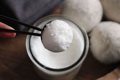 a person holding a spoon full of sugar