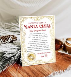 a christmas card sitting on top of a table next to some pine cones and candles