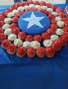 a table topped with red, white and blue cupcakes