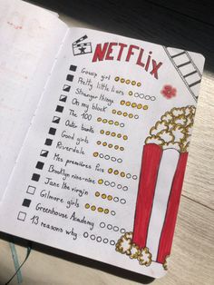 a notebook with a movie list on it