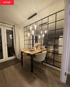 the dining room table is surrounded by glass partitions