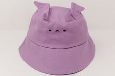 a purple hat with black eyes and ears