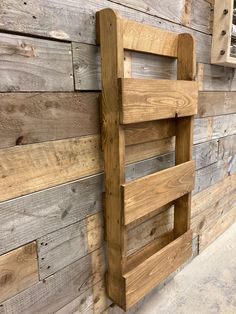 a wooden ladder mounted to the side of a wall with wood planks on it