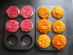 cupcakes decorated with pink and yellow icing in muffin tins