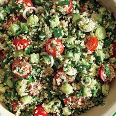 a salad with tomatoes, cucumbers and onions in a bowl