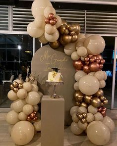 a cake and balloons are on display at a party