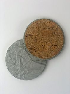 two circular cork coasters sitting on top of each other