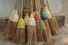 several brooms are lined up on the ground