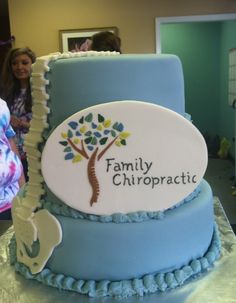 a blue cake with a family chiropratic sign on it's side