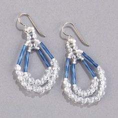 blue and white beaded chandelier earrings with silver hooks on grey background, closeup