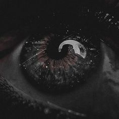 an eye is shown with the moon and stars on it's iris, in black and white