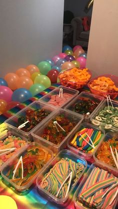 a table filled with lots of different types of candies and lollipops