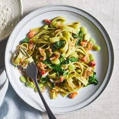 a white plate topped with pasta and vegetables