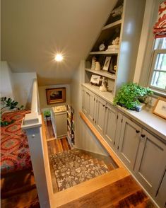 an attic bedroom with built in bookshelves and shelves