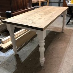 a wooden table sitting on top of a floor next to other woodworking supplies and tools