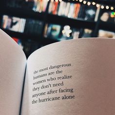 an open book with words on it in front of a bookshelf full of books