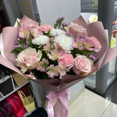 a bouquet of pink and white flowers on display