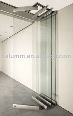 an empty room with white walls and glass partitions on the wall to let light in