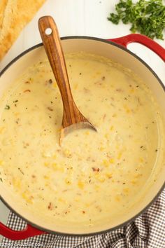 a wooden spoon in a pot filled with soup