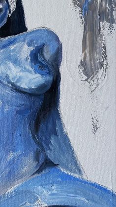 a painting of a woman with blue paint on it's face and body, sitting in front of a white wall