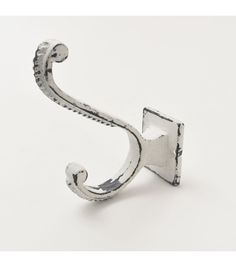 a metal hook on a white background with the letter s in it's center